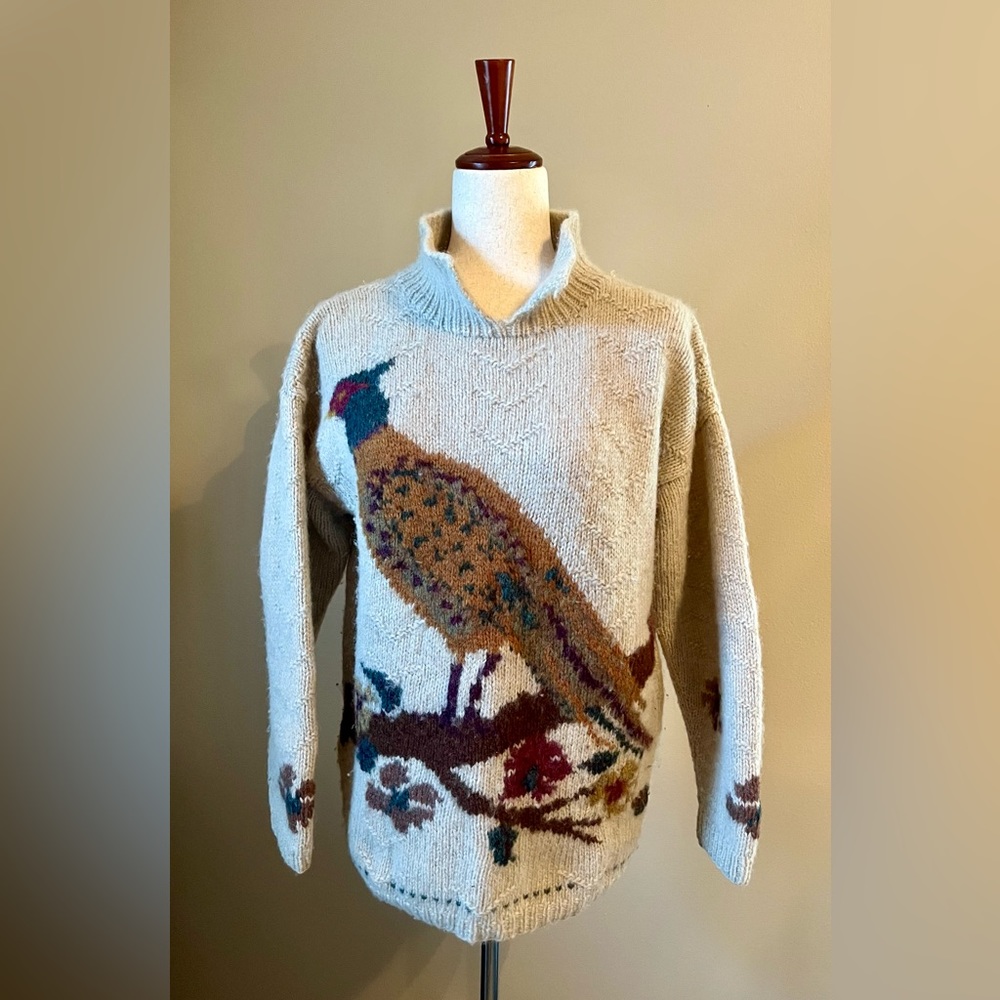 100% Wool pullover sweater with high neck and knitted bird detail in front